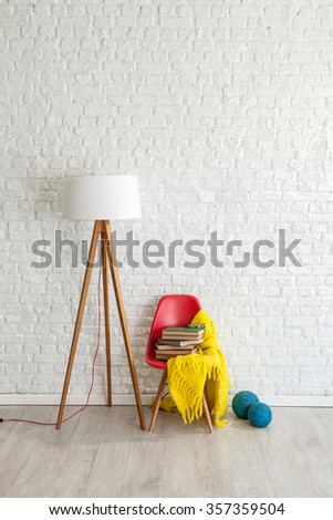 white brick wall decor and red chair