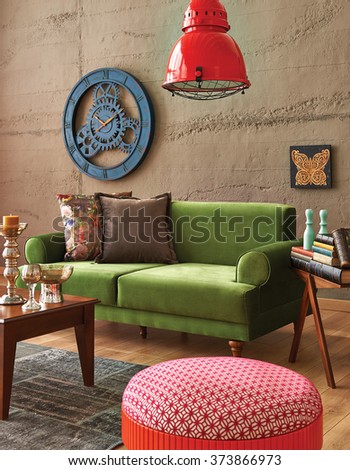 green sofa stone wall with modern red lamp