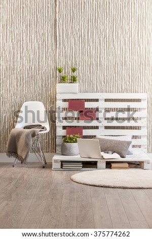 concrete wall interior handmade trendy decor with modern white chair laptop and round rug