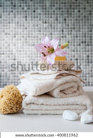 bath and towel set behind ceramic wall