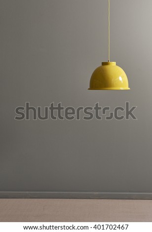 grey wall and modern yellow lamp empty room