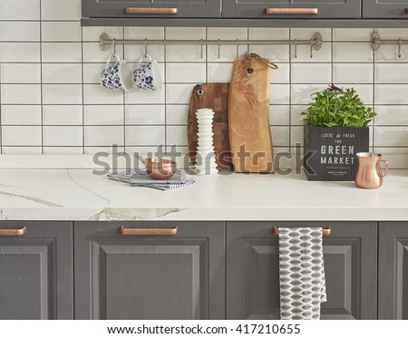 modern kitchen chopping board behind white tile wall interior trend