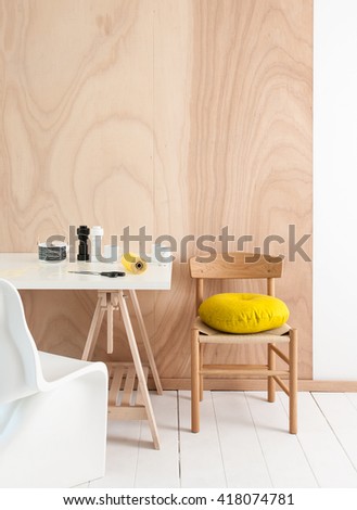 tree textured wall wood chair workspace area with yellow pillow white floor and yellow rope