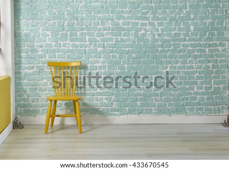 green brick wall yellow chair living room decoration