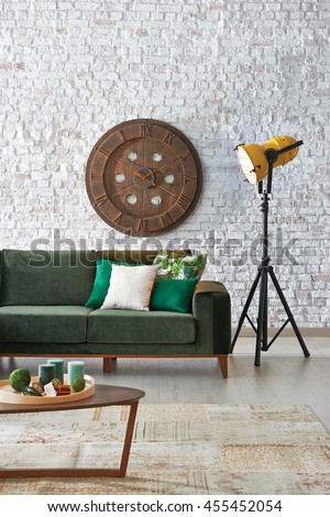 green sofa stone wall with modern red lamp