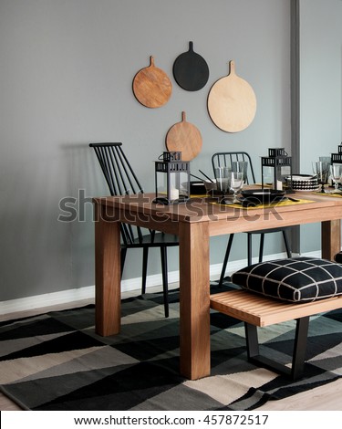 grey wall chopping board and wooden table black pillow black lantern with black white modern kitchen dining room corner