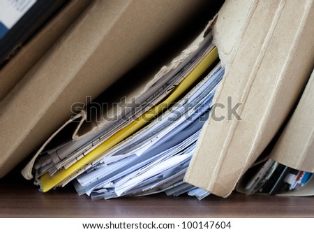torn cardboard folder with papers. bindings of old exercise books and pamphlets