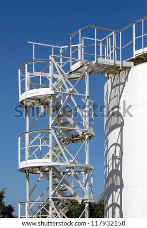 White storage tank with stairs with shadow