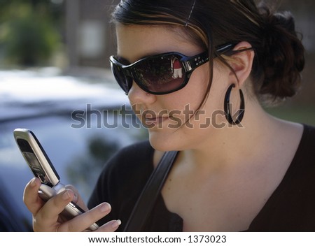 Image of a young woman looking at her cell phone