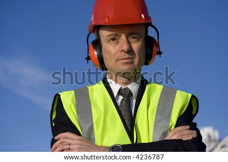 Image of a white collar worker wearing safety equipment.