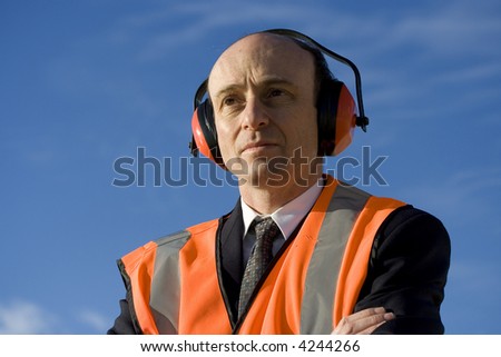 Image of a business man wearing industrial safety equipment.