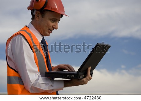Image of a white collar worker with safety gear.