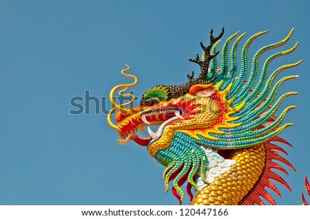Colorful dragon statue with blue sky at public park, Thailand.