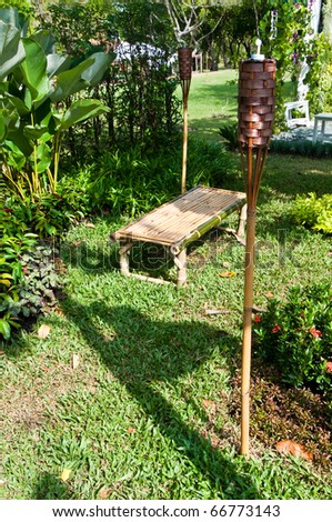 Bamboo seat, natural lamp and plant in garden, Thailand.