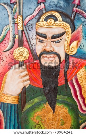 The wood carving of Chinese god on the door, Thailand.