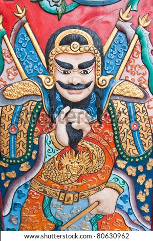 The wood carving of Chinese god on the door, Thailand.