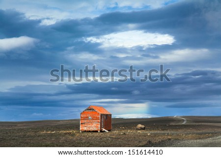 Beautiful view of barren landscape with old red snowstorm shelter at Kjolur highland road, Iceland