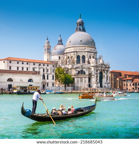 Traditional Gondola on Canal Grande with Basilica di Santa Maria della Salute in the background Venice Italy Traditional Gondola on Canal Grande with Basilica di Santa Maria della Salute in the background Venice Italy