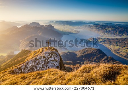 Beautiful autumn landscape in the Alps with mountain tops and lakes in golden evening light