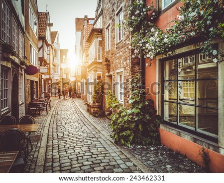 Old town in Europe at sunset with retro vintage Instagram style filter and lens flare effect