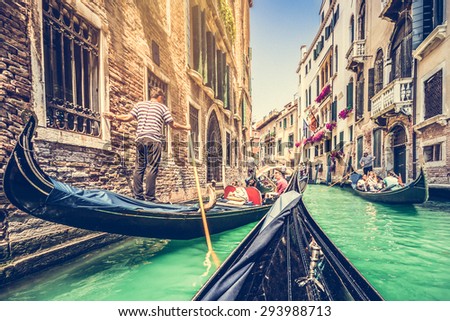 Traditional Gondolas on canal in Venice, Italy with retro vintage grunge Instagram style filter and lens flare effect