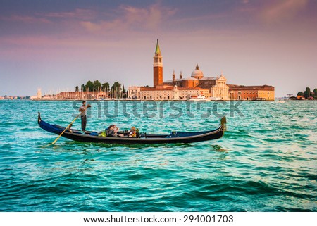 Panoramic view of traditional Gondola on Canal Grande with San Giorgio Maggiore church in the background in beautiful evening light at sunset, San Marco, Venice, Italy
