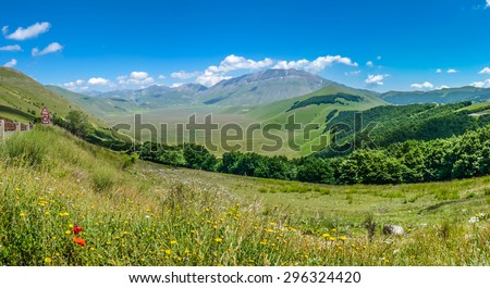 Panoramic view of beautiful summer landscape at Piano Grande (Great Plain) mountain plateau in the Apennine Mountains, Castelluccio di Norcia, Umbria, Italy