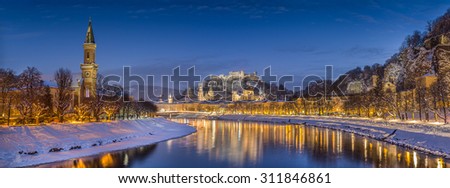 Panoramic view of the historic city of Salzburg with Salzach river in winter during blue hour, Salzburger Land, Austria