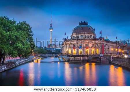 Beautiful view of Museumsinsel (Museum Island) with famous TV tower and Spree river in twilight during blue hour at dusk, Berlin, Germany