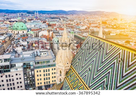 Aerial view over the rooftops of Vienna from the south tower of St. Stephen's Cathedral including the cathedral's famous ornately patterned, multi colored roof created by 230,000 glazed tiles, Austria