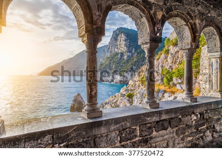 Columns of famous gothic Church of St. Peter (Chiesa di San Pietro) with beautiful shoreline scenery at sunset in the town of Porto Venere, Ligurian Coast, province of La Spezia, Italy
