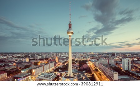 Aerial view of Berlin skyline with famous TV tower and dramatic clouds in twilight during blue hour at dusk with retro vintage Instagram style nostalgic pastel toned filter effect, Germany