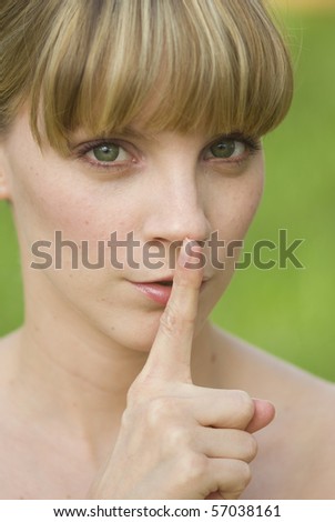 Girl with a finger in front of her mouth