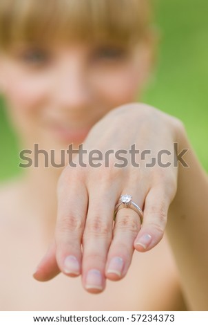 A woman showing an engagement ring