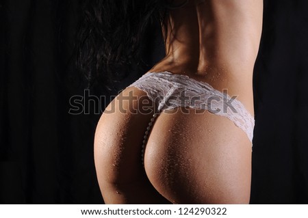 Sexy back of a curvy woman wearing a white thong