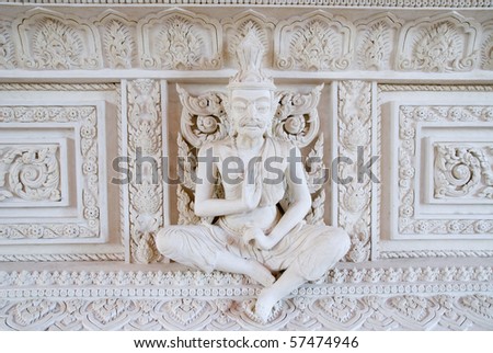 detail of white statue on the wall