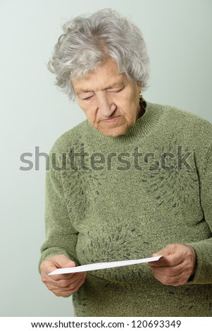 Portrait of senior woman reading paper