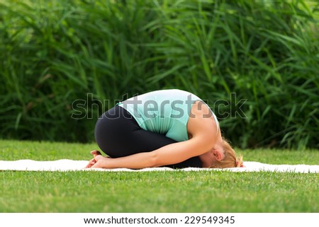 Woman exercise yoga asana child pose