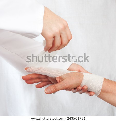 Nurse cover the hand of patient by bandage