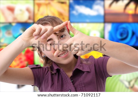 Happy young woman making a frame with her hand