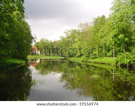 View of a river and parks with a small house nearby, Estonian nature