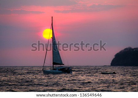 Sailboat Sunset Costa Rica. A lone sailboat against a sunset in the pacific ocean off the coast of Costa Rica.