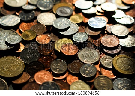 World Coins 3. A collection of various coins from around the world. Narrow depth of field, only center coins in focus.