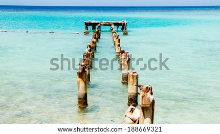 Jamaica Blue Docks 1. The remains of an old dock off a Caribbean white sand beach on the northern coast of Jamaica, near Dunn\'s River Falls and the town of Ocho Rios.