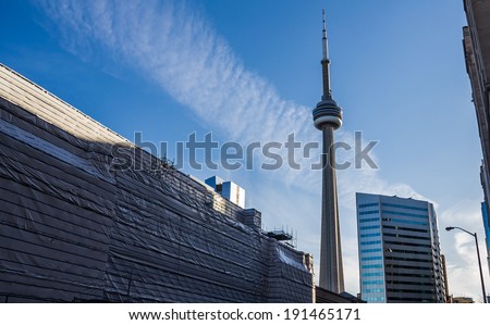 TORONTO - CIRCA APR 2014: The CN Tower and Union Station in Toronto, Canada, which is under renovation at the time of this image, May 6th 2014. Viewed from Front Street just west of Bay Street.