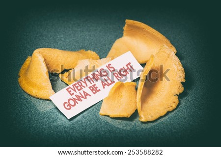 Fortune Cookie Everything is Gonna be All Right. A cracked open fortune cookie from a Chinese restaurant with the phrase, \