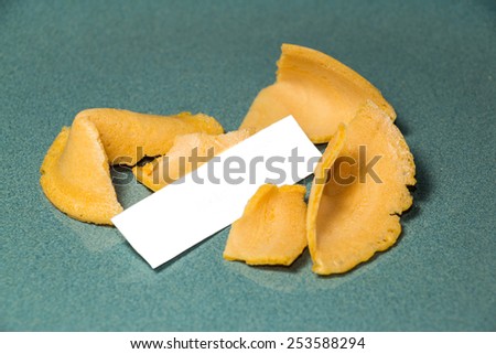 Fortune Cookie Blank. A cracked open fortune cookie from a Chinese restaurant with blank space from a customized paper fortune.
