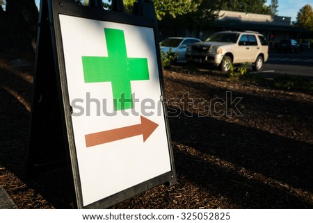 Green Cross Sign Retail Cannabis Portland. Green cross symbol advertising a legal retail cannabis dispensary in Portland, Oregon.