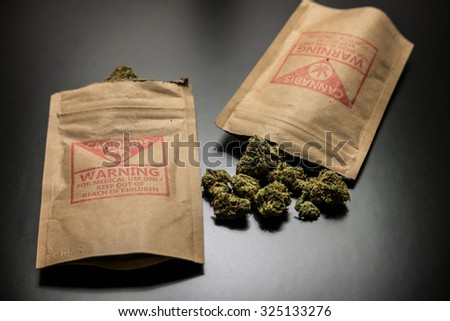 Legal Cannabis Flowers and Packages. Legal cannabis and it's package purchased from a retail storefront in Portland, Oregon.