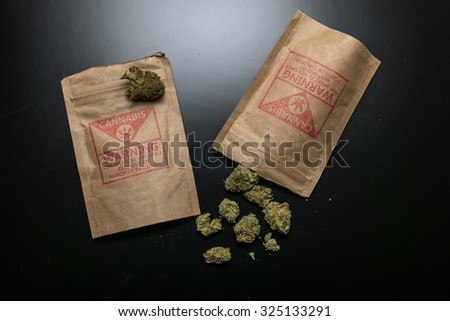 Legal Cannabis Flowers and Packages. Legal cannabis and it\'s package purchased from a retail storefront in Portland, Oregon.